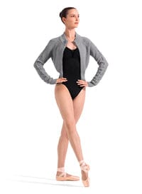 Ballerina in a black leotard and gray cardigan on a white background