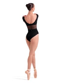 Ballerina in a black leotard and tights on a white background