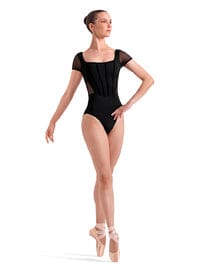 Ballet dancer in a black leotard on a white background