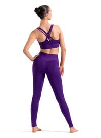 Woman wearing a purple athletic outfit on a white background