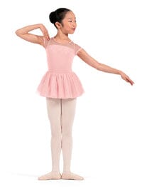 Young girl in a pink ballet outfit on a white background