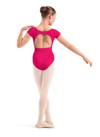 Ballerina in a pink leotard and beige tights on a white background