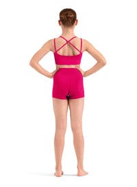 Person wearing a pink leotard with a criss-cross back design on a white background