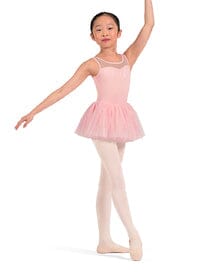 Young girl in a pink ballet outfit posing on a white background