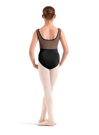 Ballet dancer in a black leotard and beige tights on a white background