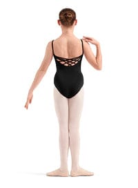 Ballerina in a black leotard with open back and white tights on a white background