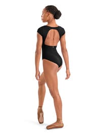 Dancer wearing a black leotard with open back on a white background