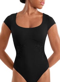 Black bodysuit worn by a model against a neutral background
