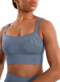 Woman wearing a blue sports bra with lace details