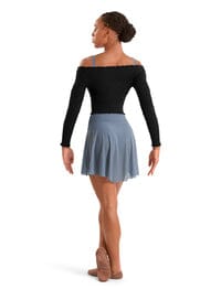 Dancer wearing a black top and blue skirt on a white background