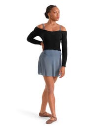 Woman wearing a black top and blue skirt on a white background