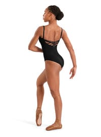 Dancer wearing a black leotard with lace details on a white background