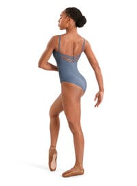 Dancer in a blue leotard and pointe shoes on a white background