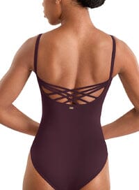 Person wearing a burgundy swimsuit with cut-out design on a white background