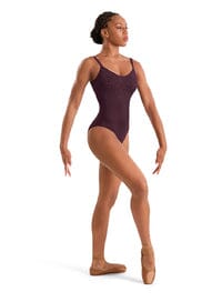 Dancer in a burgundy leotard on a white background