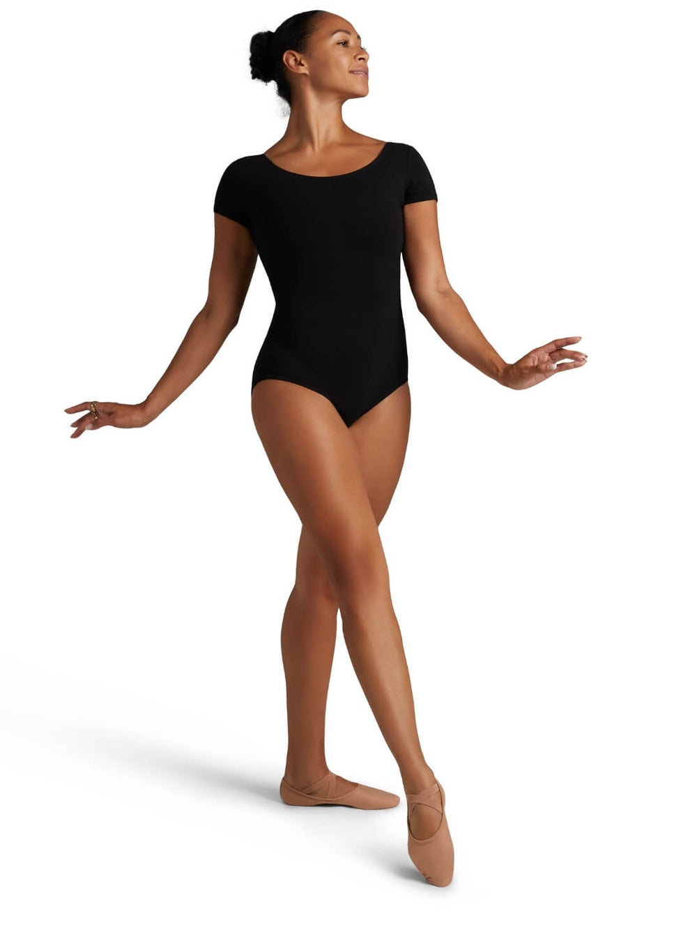 Dancer wearing a black leotard on a white background