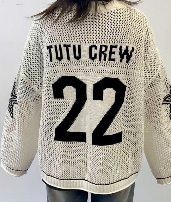 Beige sweater with 'TUTU CREW 22' text on a plain background