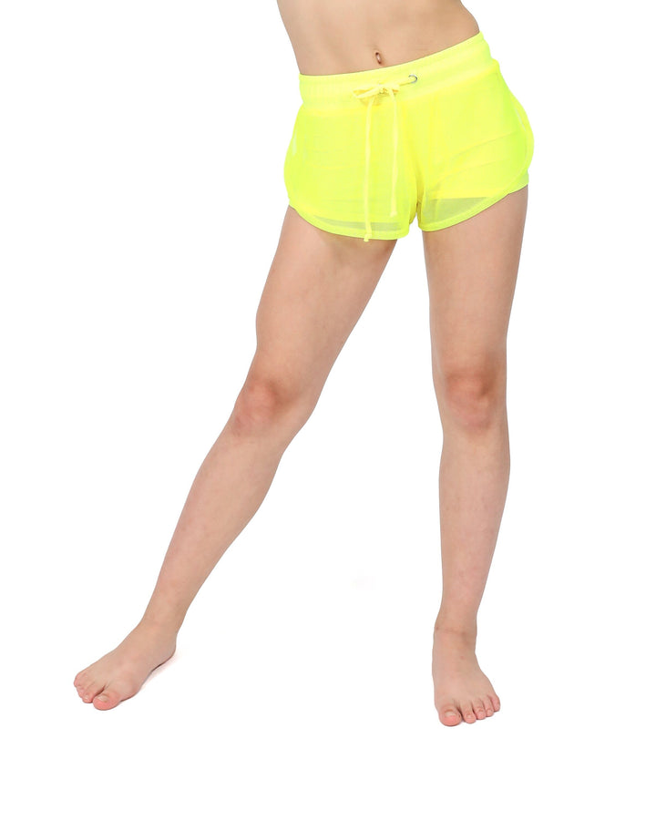 Neon yellow shorts worn by a person on a white background