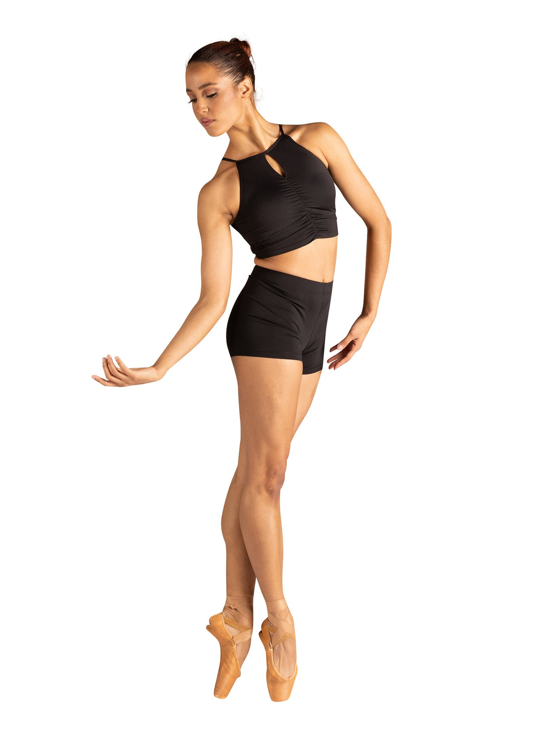 Dancer in a black leotard and tights on a white background