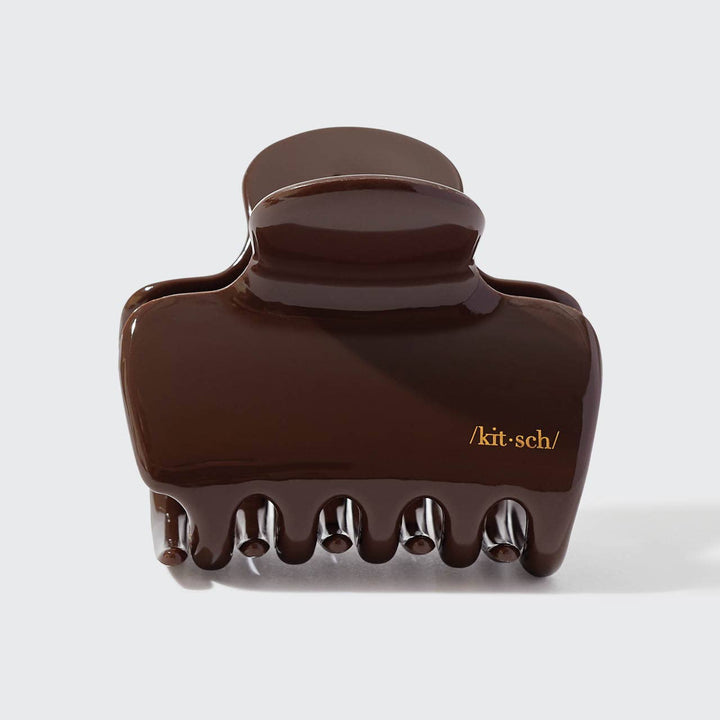 Brown hair clip with 'kit-sch' branding on a white background