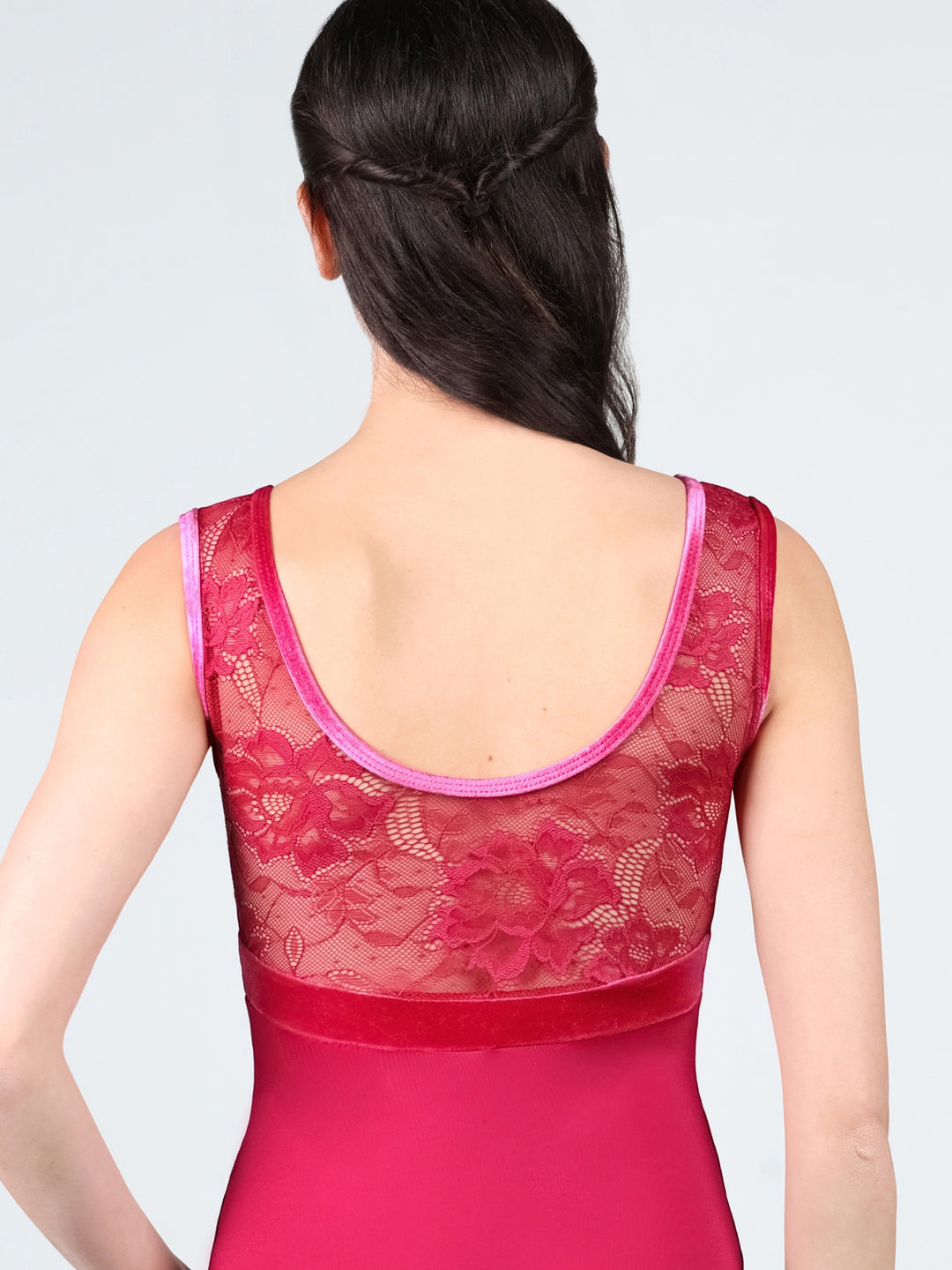 Red lace top worn by a person on a light gray background