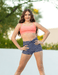 Woman in athletic wear standing outdoors with a blurred natural background