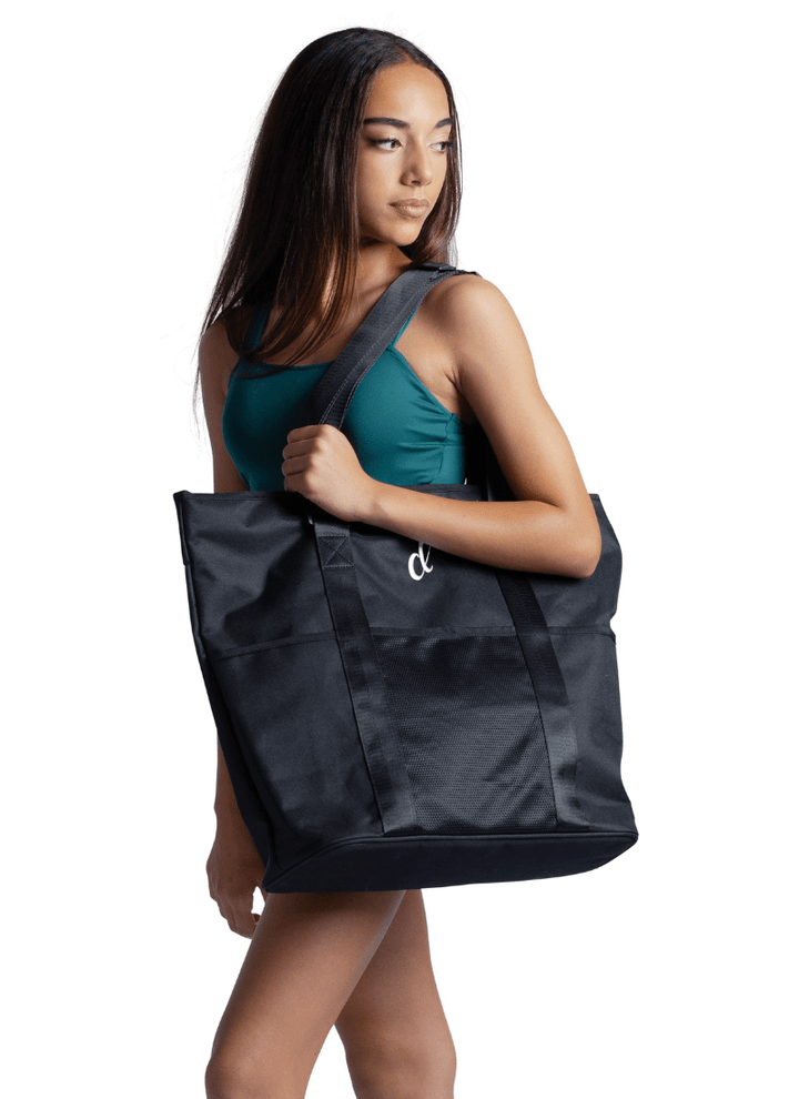 Woman carrying a black tote bag on a white background
