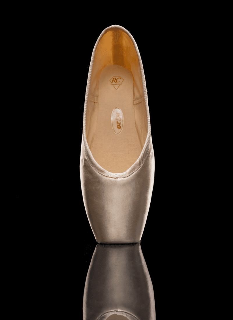Gold high-heeled shoe on a black background
