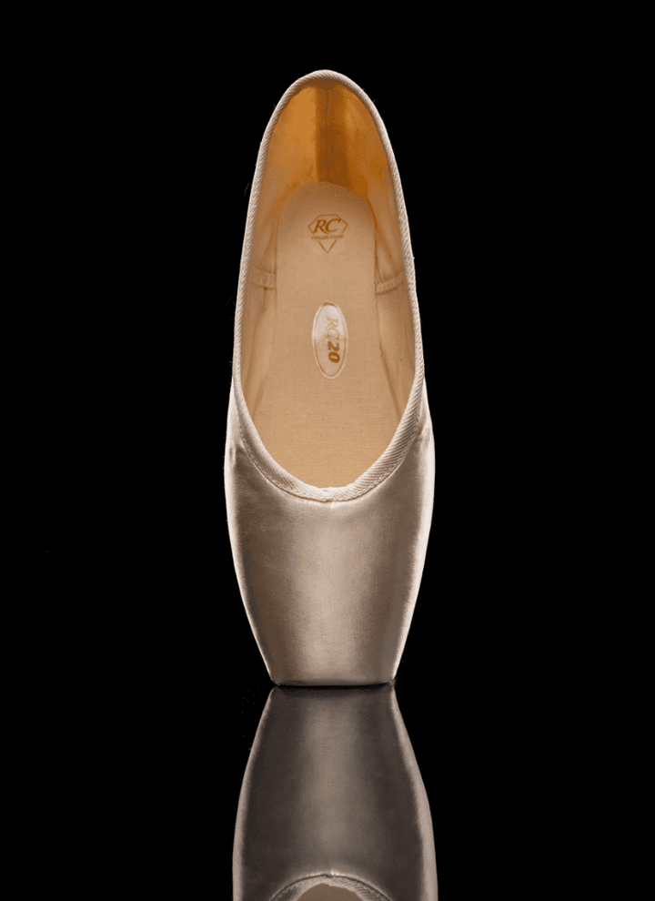 Gold high-heeled shoe on a black background