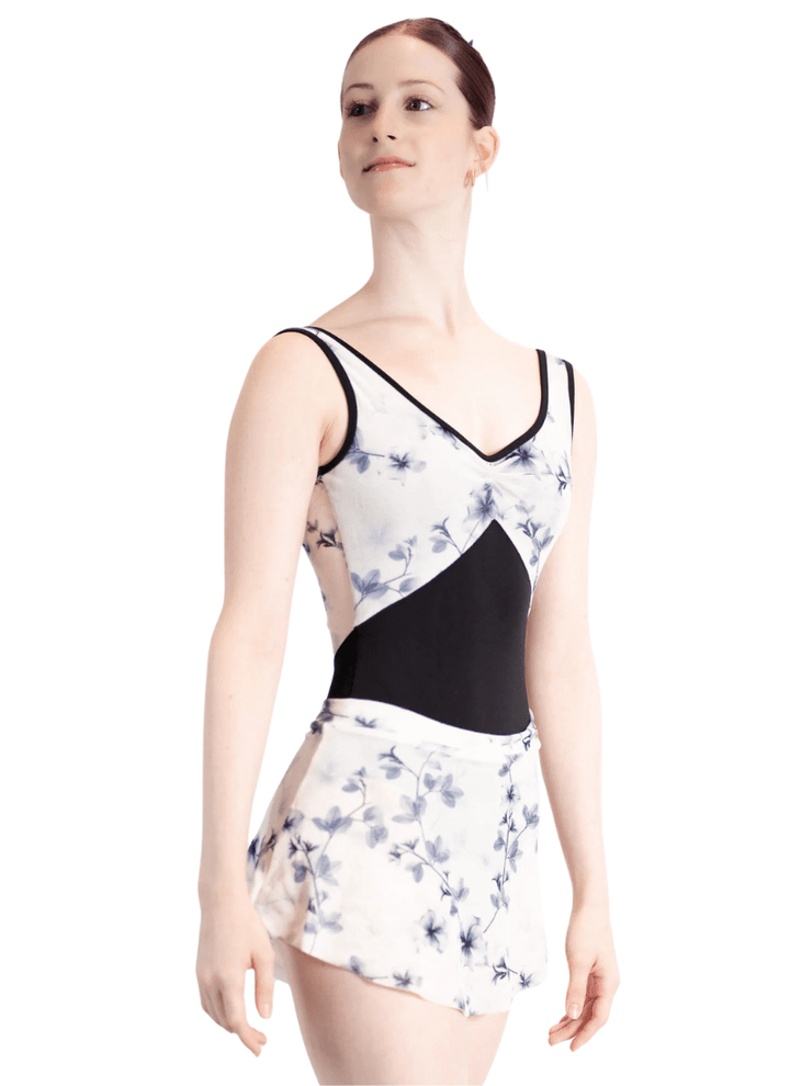Woman wearing a floral leotard with a black accent on a white background