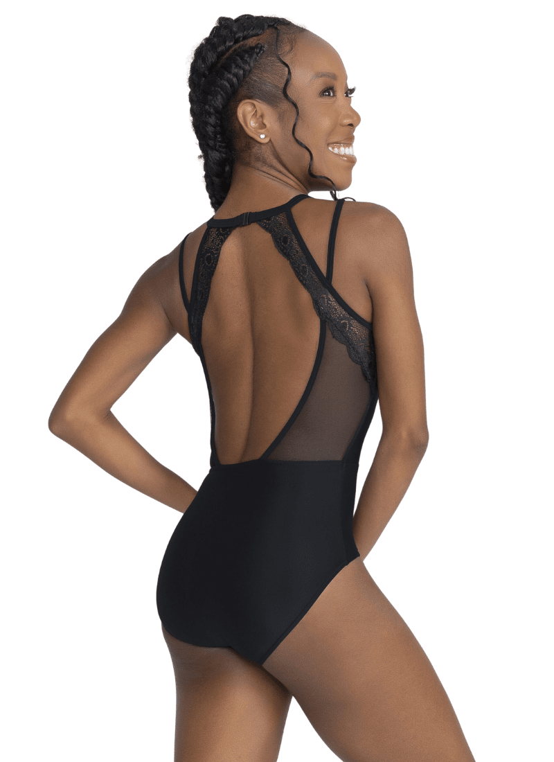 Model wearing a black lace bodysuit on a white background