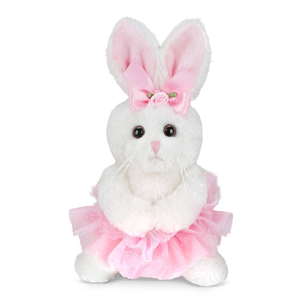 White plush bunny with pink bow and skirt on a white background