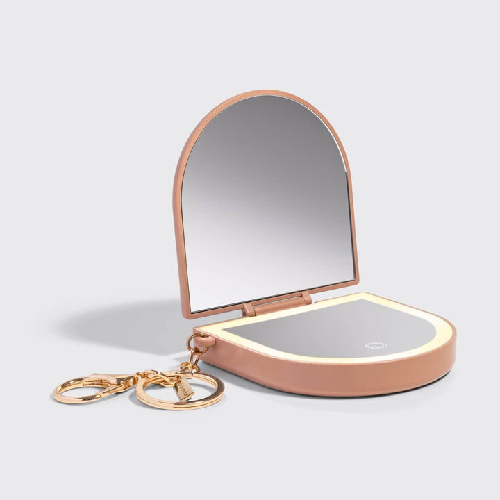 Compact mirror with LED lighting on a gray background