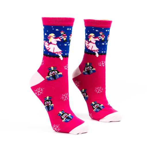 Pair of pink and blue socks with festive designs on a white background