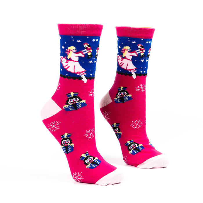 Pair of pink and blue socks with festive designs on a white background