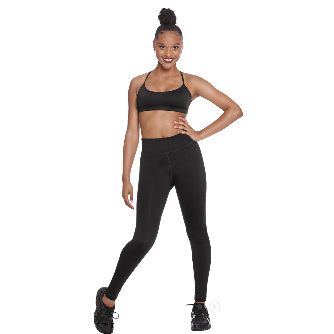 Woman wearing a black sports bra and leggings on a white background