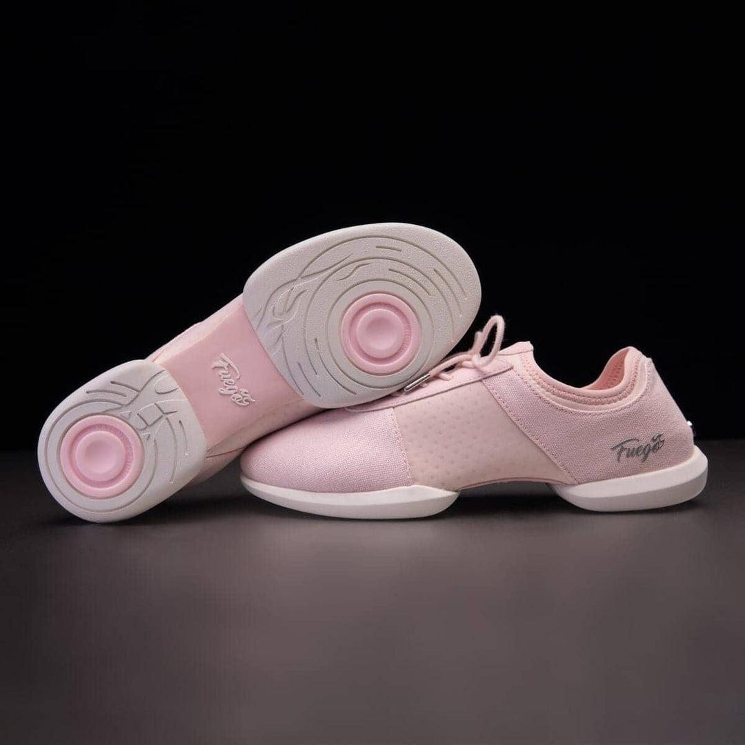 A pair of pink dance sneakers with split-sole design, featuring the brand name 'Fuego' on the sole and a silver flame design on the lace tips.