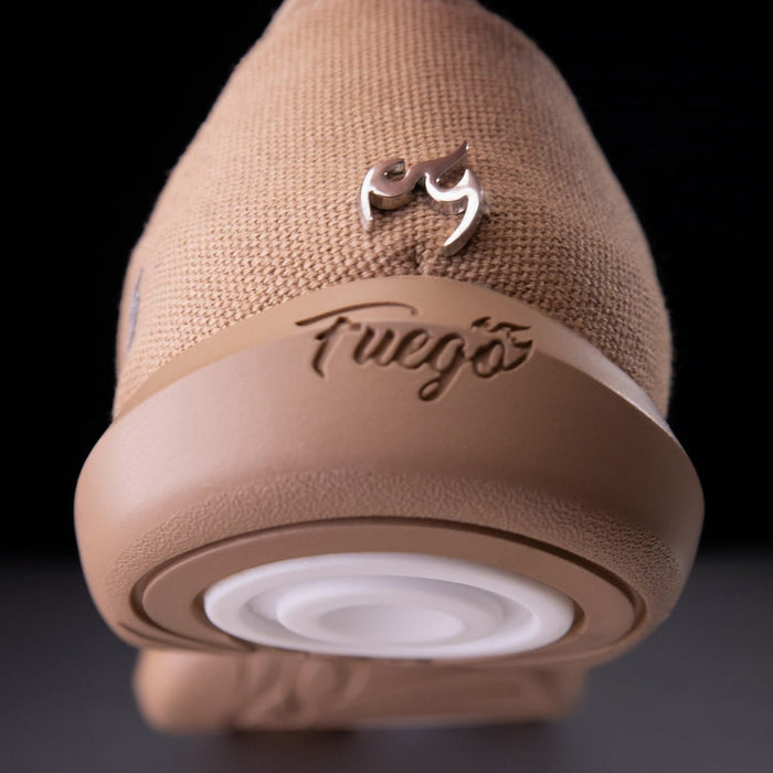 Close-up of a beige speaker with 'Fwoosh' branding on a dark background