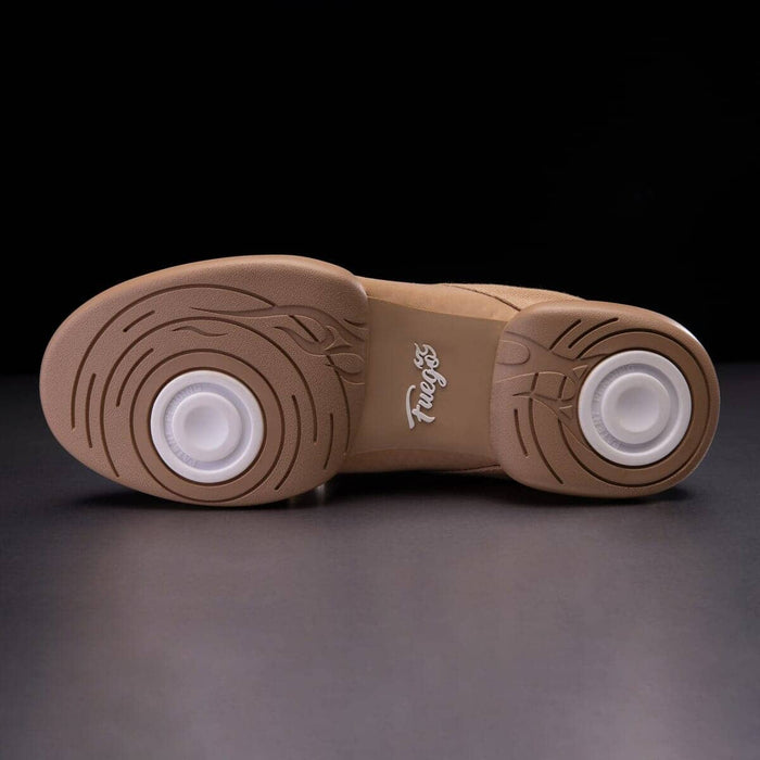 Tan sole of a shoe with white rubber outsole on a dark background