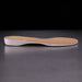 Shoe insole with beige insert on a reflective surface
