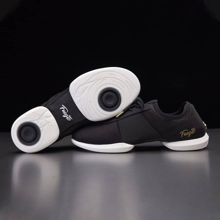 A pair of black dance sneakers with white soles, featuring the Fuego brand logo on the side.