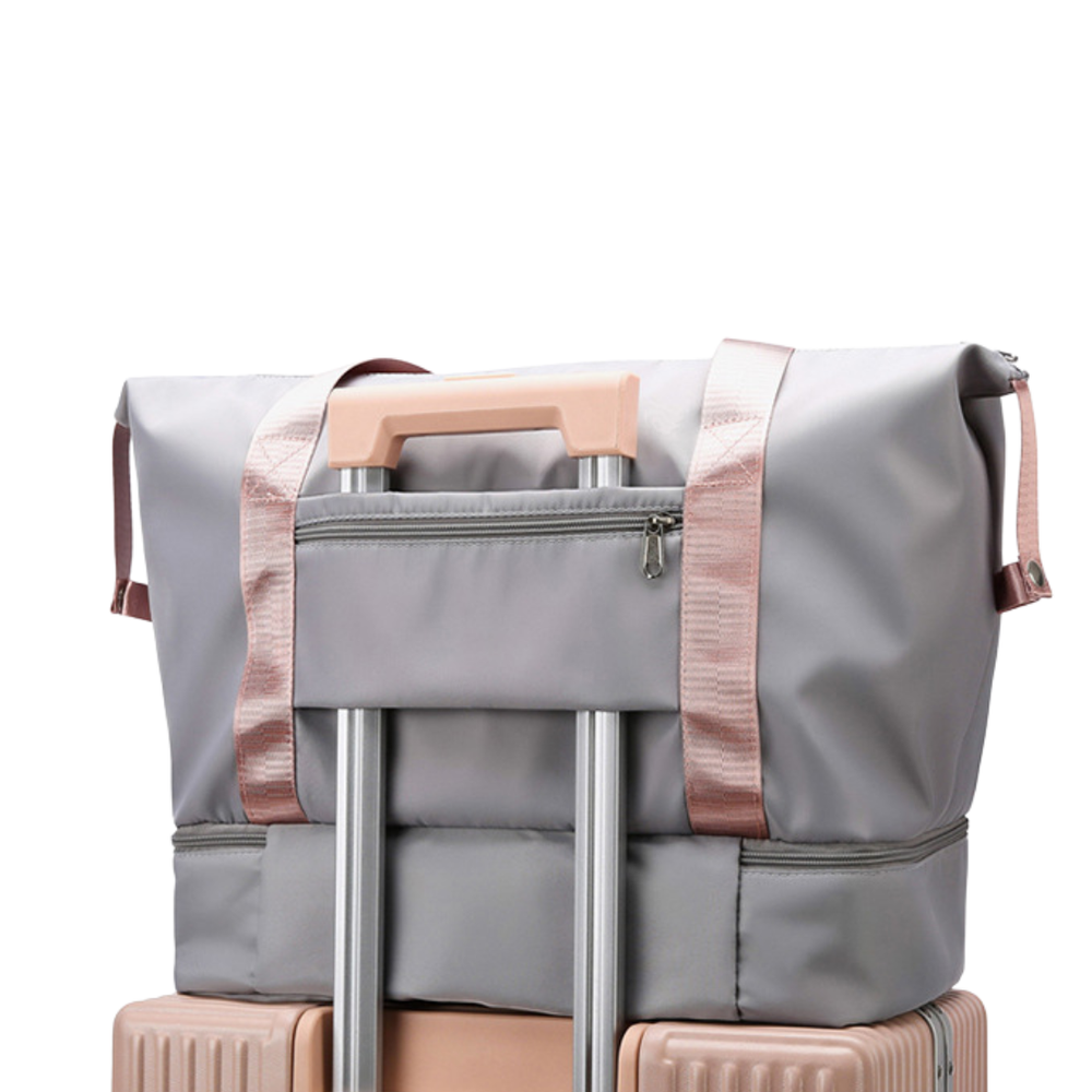 Gray suitcase with pink straps on a white background
