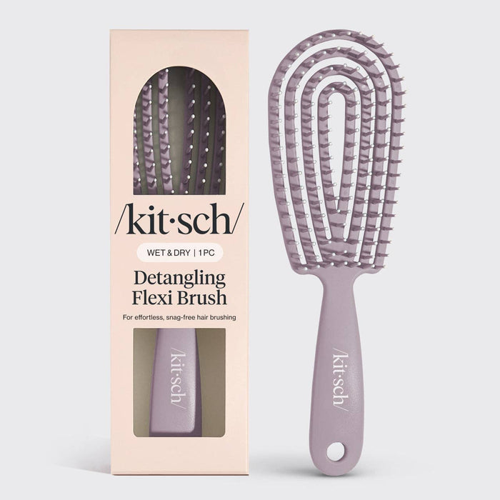 Detangling flexi brush with 'kitsch' branding next to its packaging on a light gray background