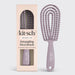 Detangling flexi brush with 'kitsch' branding next to its packaging on a light gray background
