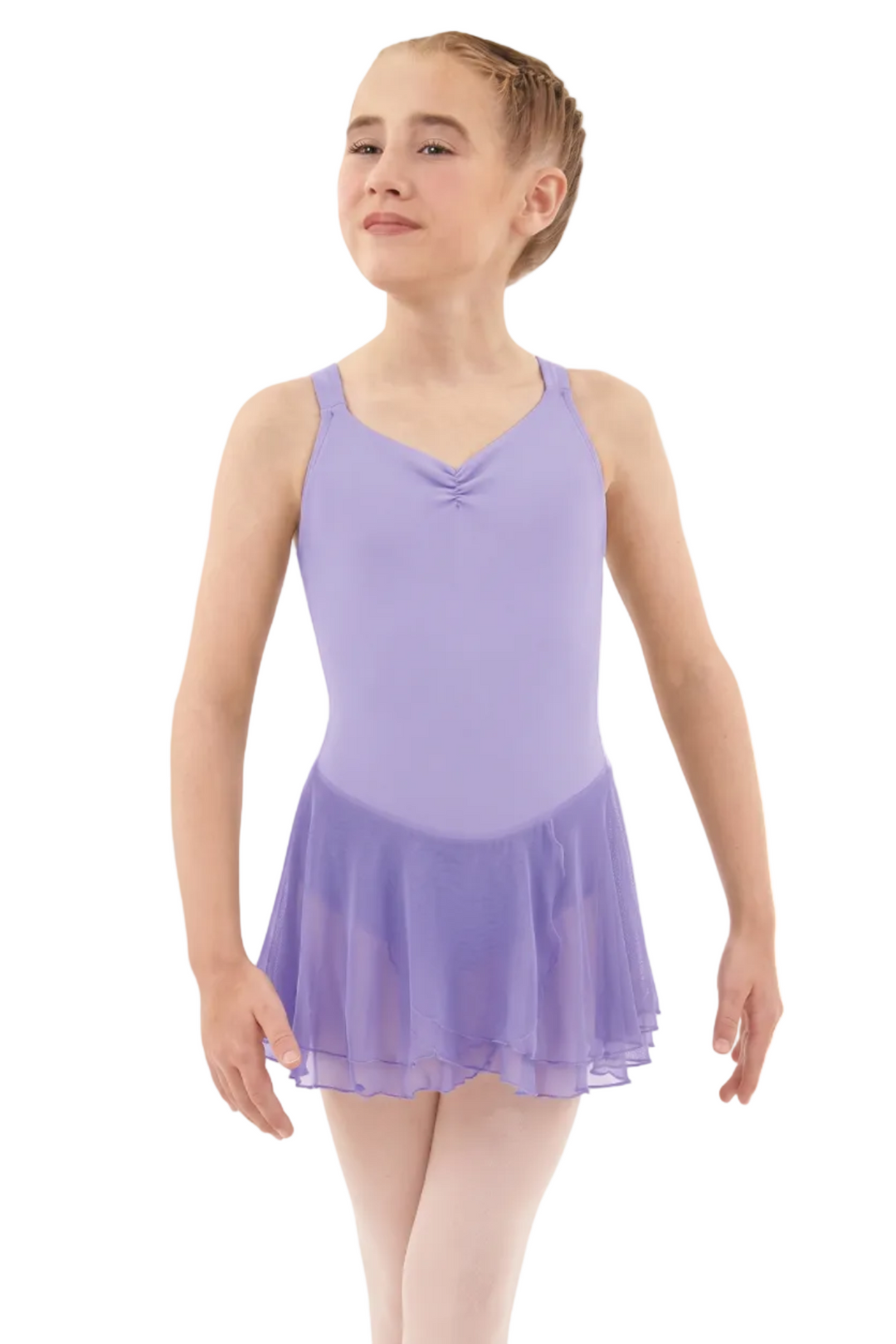 Young girl wearing a purple leotard with a skirt on a white background