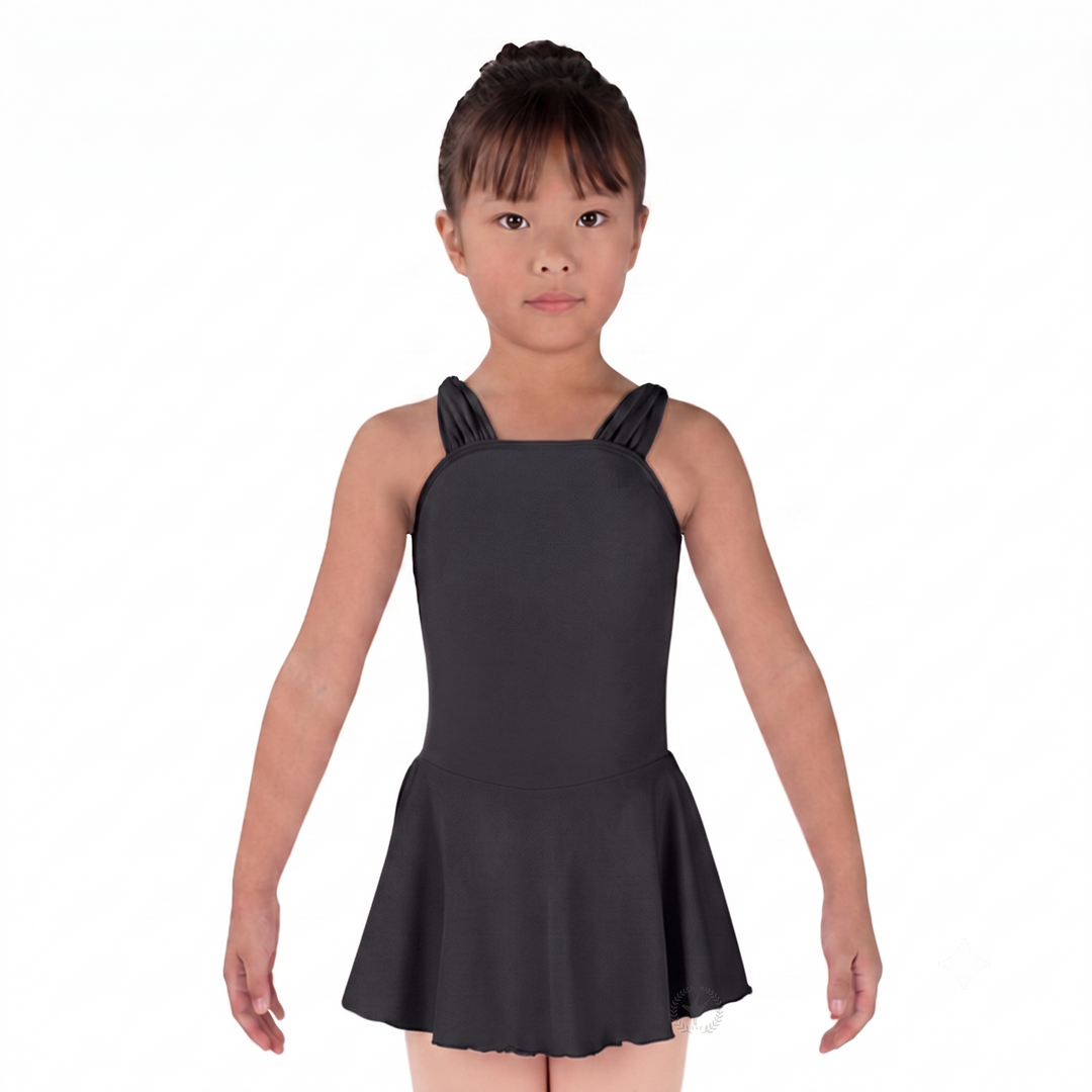 Young girl wearing a black dress with ruffled straps on a white background