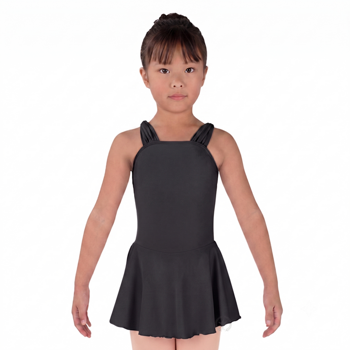 Young girl wearing a black dress with ruffled straps on a white background