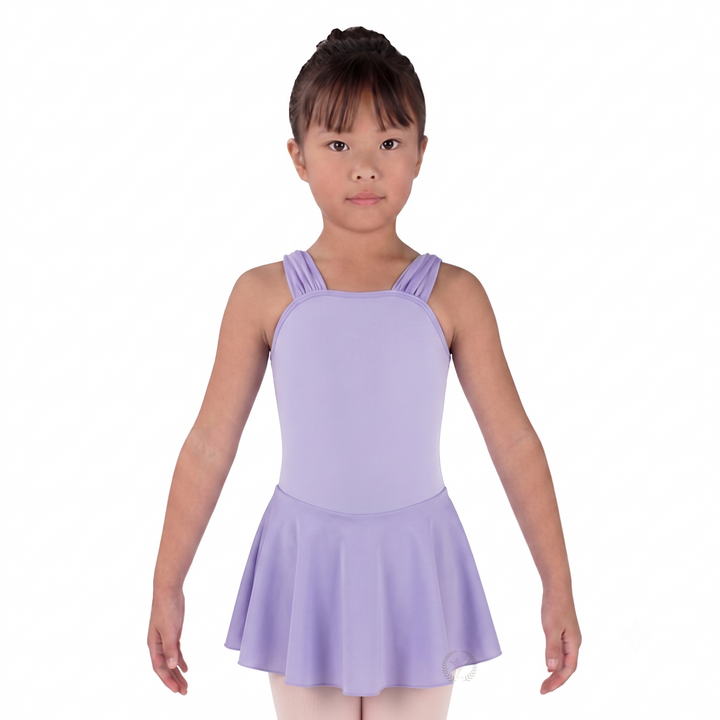 Young girl wearing a purple leotard with a skirt on a white background
