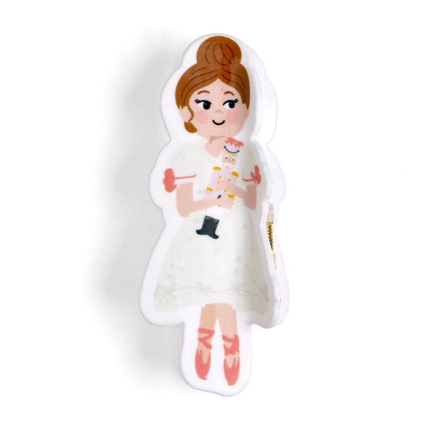 A die-cut decorative pin or badge featuring an illustrated girl with brown hair in a bun, wearing a white dress and pink shoes, holding a small white cat. The pin is shown on a plain white background with a soft shadow.