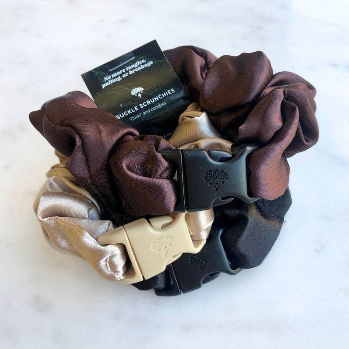 Set of three scrunchies with a black card on a white background